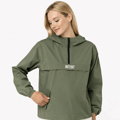 Woman wearing a green raincoat with 'Intent' branding on a white background