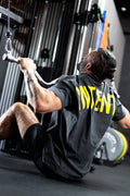 Person exercising using a cable machine in a gym setting
