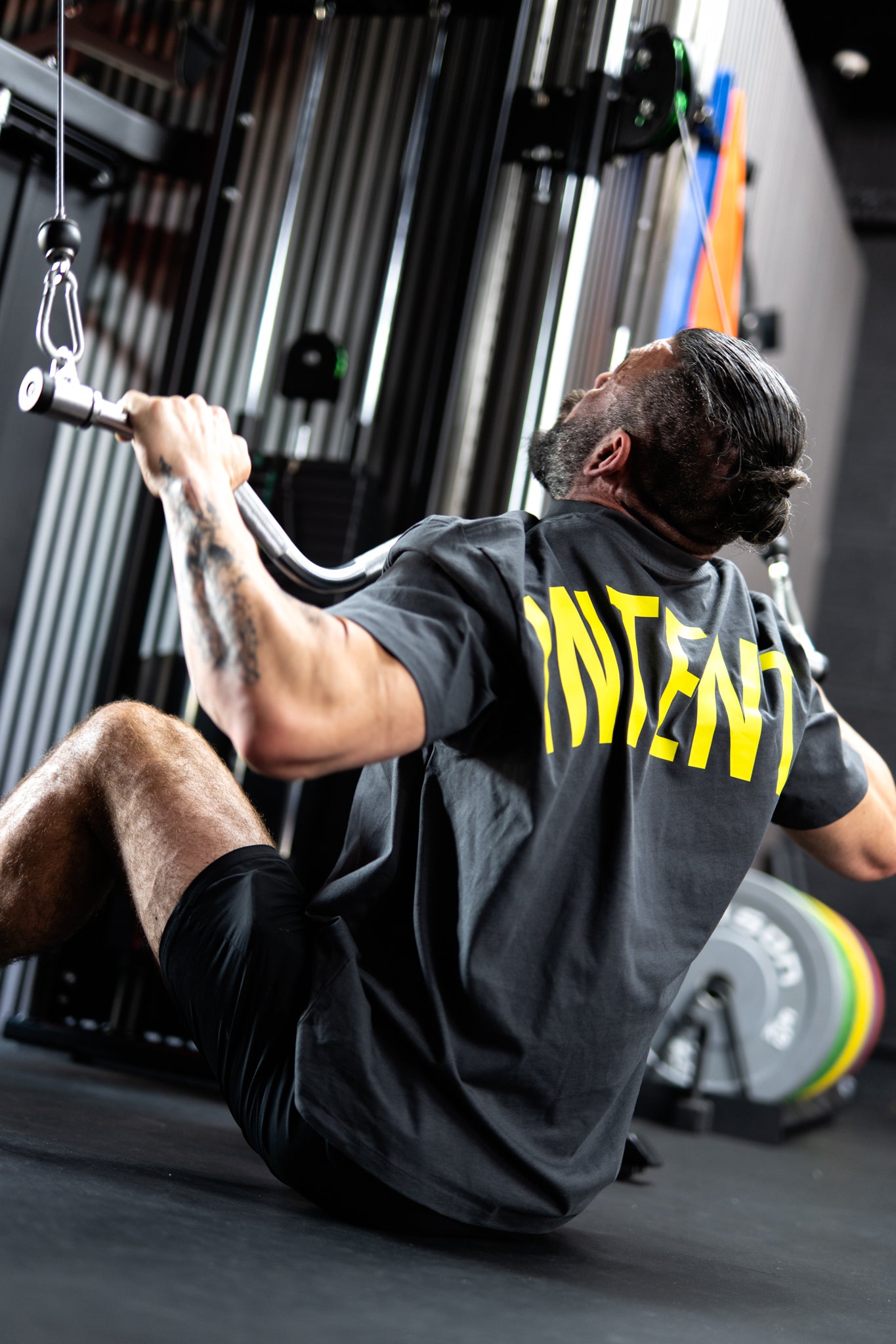 Person exercising using a cable machine in a gym setting