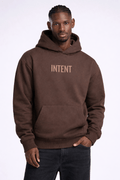 Man wearing a brown hoodie with 'INTENT' text on a white background
