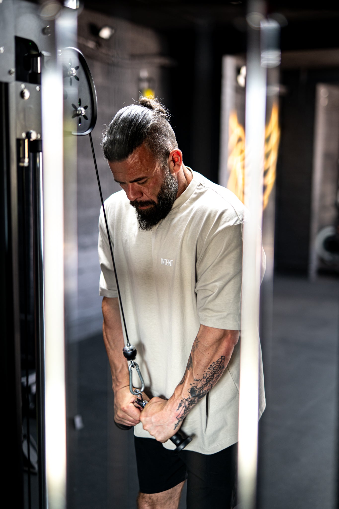 Man exercising in a gym using resistance bands.