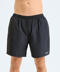 Black shorts worn by a person on a light gray background