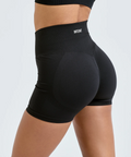 Black athletic shorts with 'Intent' branding on a light gray background