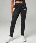 Black jogger pants with a brand logo on a gray background