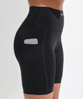 Black athletic shorts with a pocket on a light gray background