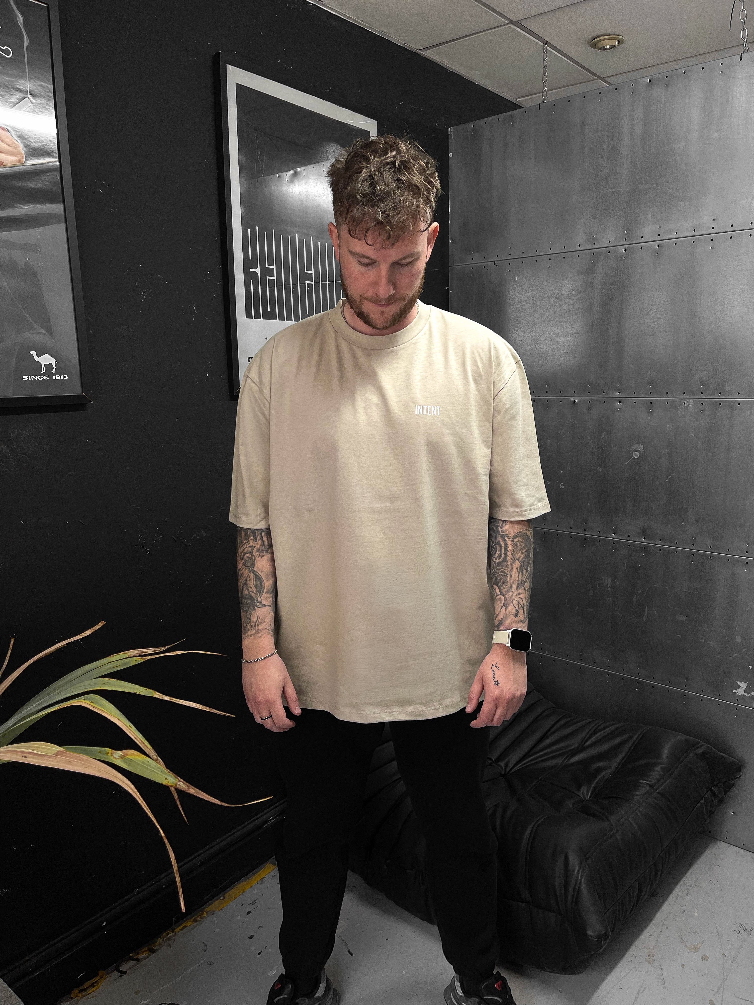 Man standing in a room with black walls and a plant