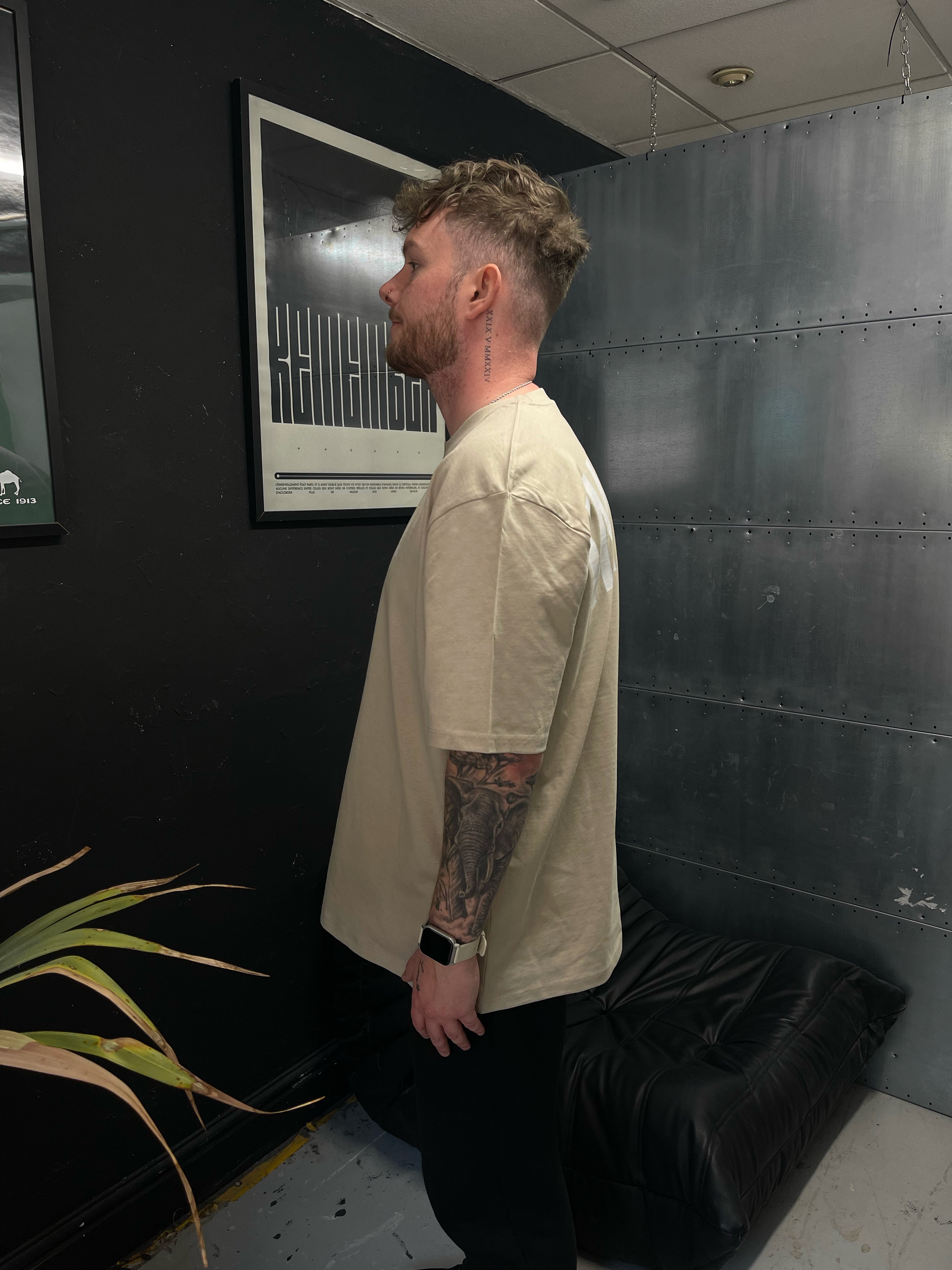Man with tattoos wearing a stone intent t-shirt lift collection